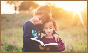 Two children reading a book and thinking of the future
