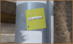 Sticker with disorder written on stuck to a lampost