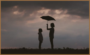 a woman offering a child an umbrella
