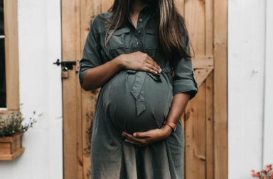 An autistic woman holding her pregnancy bump