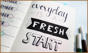 A diary with 'everyday is a fresh start' written in it