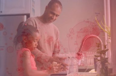 An autistic girl and her father washing their hands to protect from Covid-19