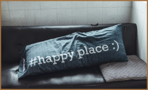 A pillow with #happy place written on it
