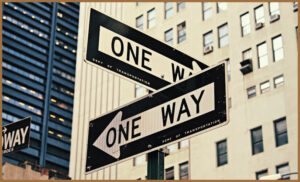 Two one way signs pointing opposite directions