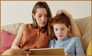 An autistic boy with his mum on an AAC