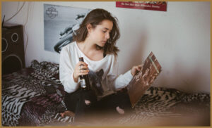 An autistic woman looking at a record with a bottle in her hand