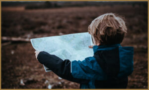 An autistic boy looking at a map